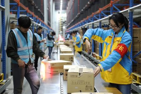 Employees scan parcels at a logistics base of Suning ahead of the Singles Day online shopping festival in Nanjing, Jiangsu province, China November 7, 2017. REUTERS/Stringer