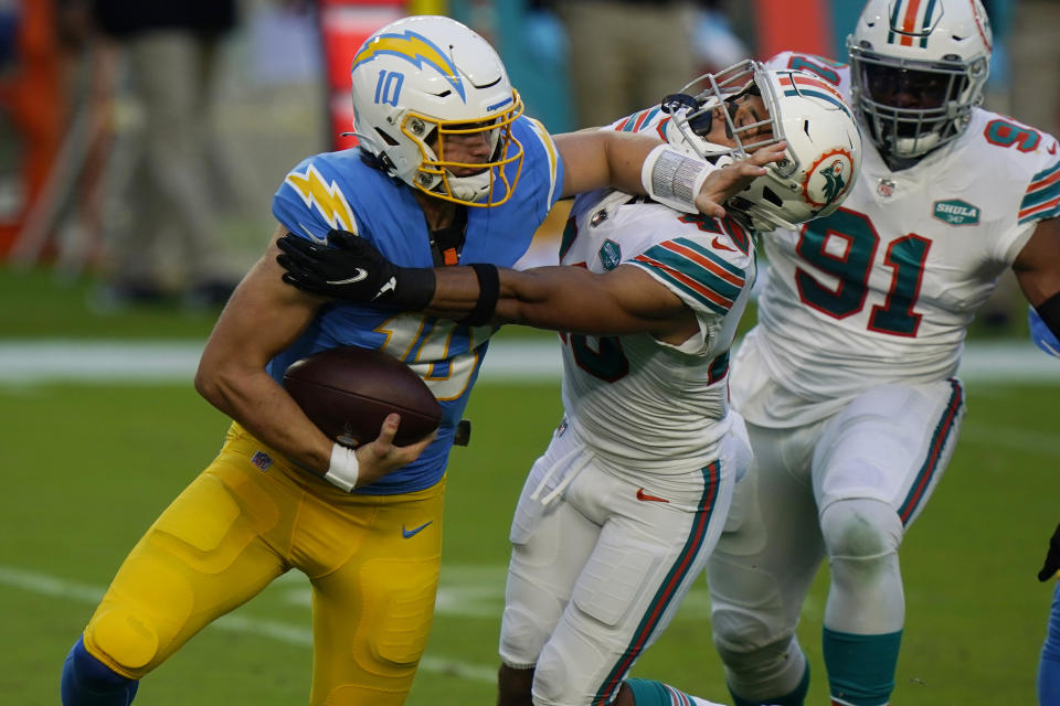 Miami Dolphins defensive back Nik Needham (40) sacks Los Angeles Chargers quarterback Justin Herbert (10), during the first half of an NFL football game, Sunday, Nov. 15, 2020, in Miami Gardens, Fla. (AP Photo/Wilfredo Lee)