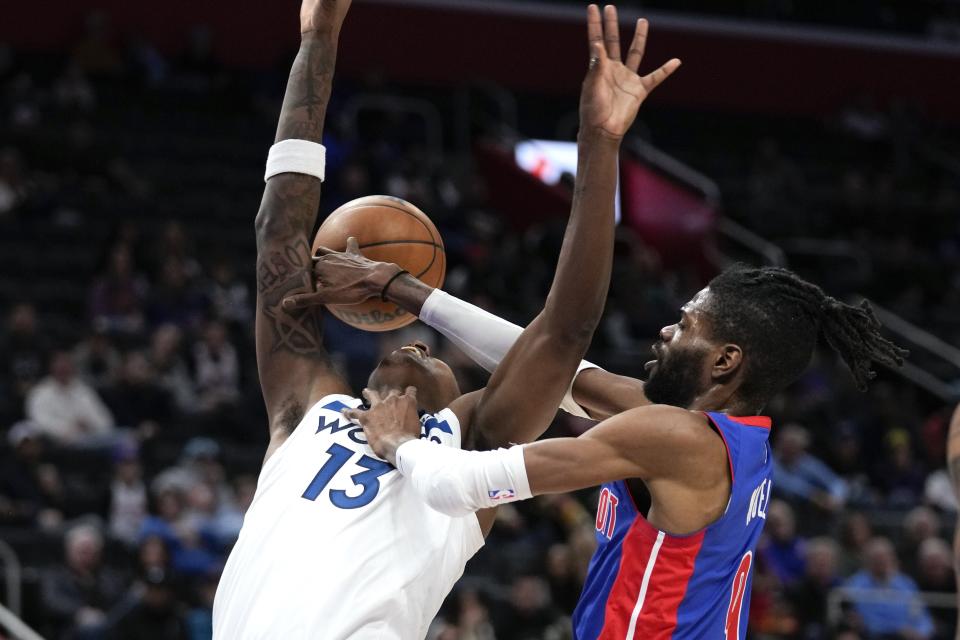 Detroit Pistons' Nerlens Noel (9) fouls Minnesota Timberwolves forward Nathan Knight (13) in the second half at Little Caesars Arena in Detroit on Wednesday, Jan. 11, 2023.