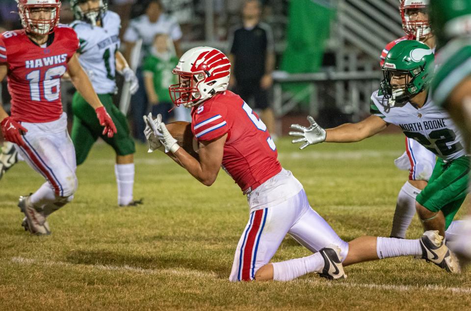 Oregon's Hunter Bartel intercepts a pass intended for North Boone's Julian Ridriguez in the fourth quarter of their game in Oregon on Friday, Aug. 25, 2023.