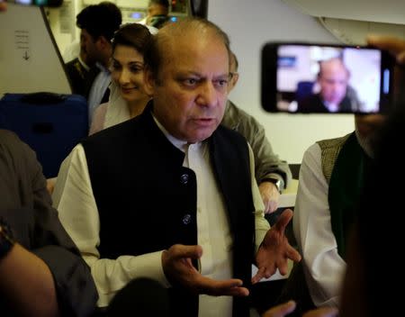 Ousted Pakistani Prime Minister Nawaz Sharif gestures as he boards a Lahore-bound flight due for departure, at Abu Dhabi International Airport, UAE July 13, 2018. REUTERS/ Drazen Jorgic