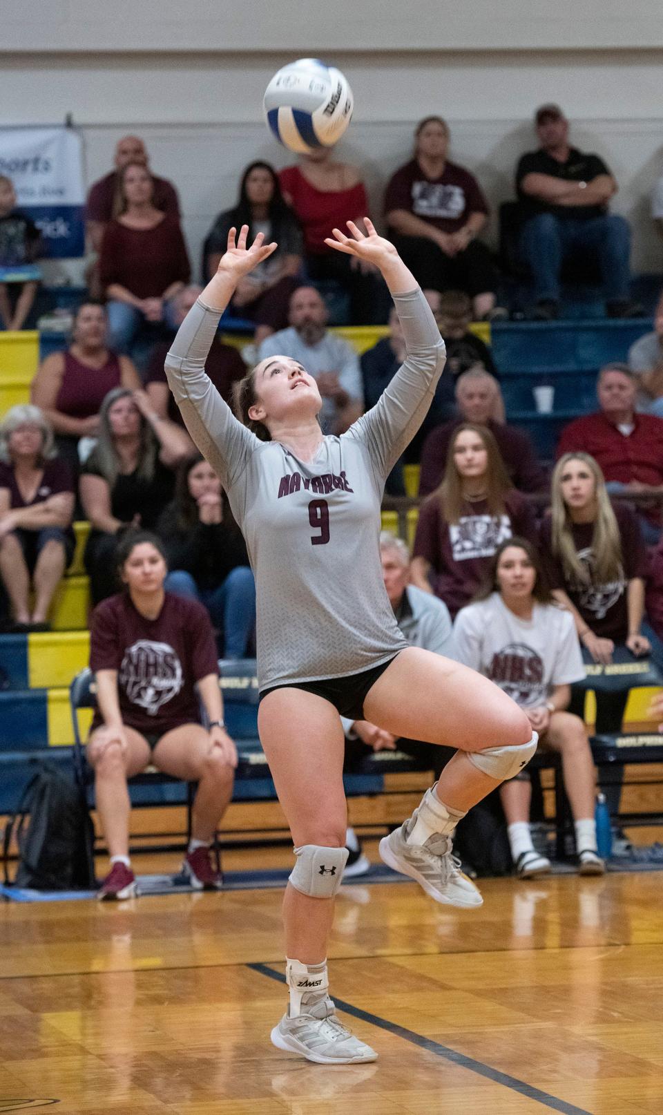 Navarre High School's Julia Irmen (No. 9) sets her teammates during Wednesday's Region 1-6A quarterfinals match against Gulf Breeze High. Navarre dropped three straight to the Dolphins  25-20, 25-18, 25-16.