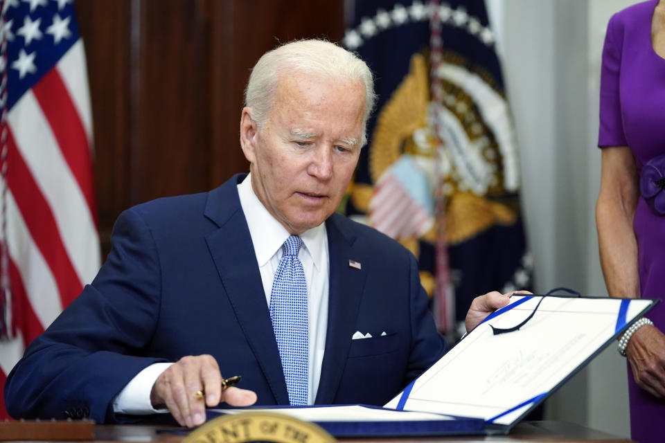 FILE - President Joe Biden signs into law S. 2938, the Bipartisan Safer Communities Act gun safety bill, in the Roosevelt Room of the White House in Washington, June 25, 2022. Bipartisan gun legislation signed by President Biden in 2022 has already prevented some potentially dangerous people from owning guns. But Democrats are calling for more action after mass shootings in Nashville and elsewhere, and Congress is at a familiar impasse. (AP Photo/Pablo Martinez Monsivais, File)