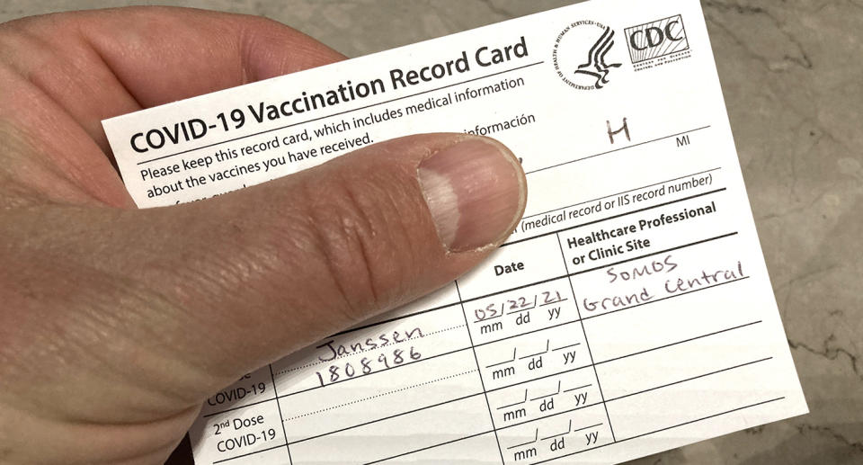 Photo of someone holding a Covid-19 vaccination card in the USA.