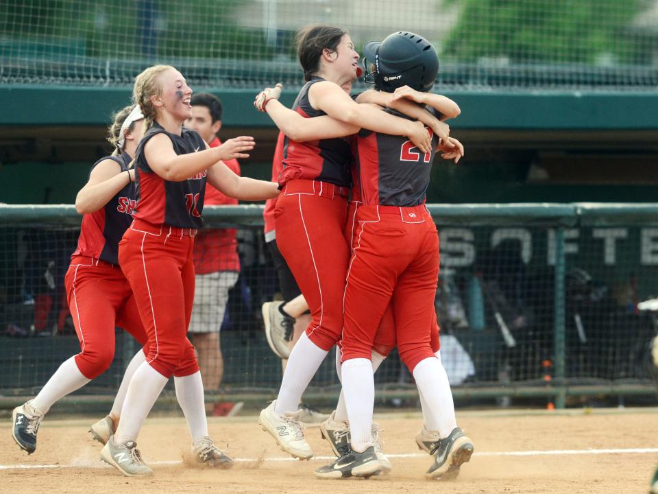 Sheridan players mob freshman Payton Powell after her game-winning two-run double in the bottom of the seventh inning of a 7-6 win against during a Division II district final on May 19, 2022, at Ohio University in Athens.