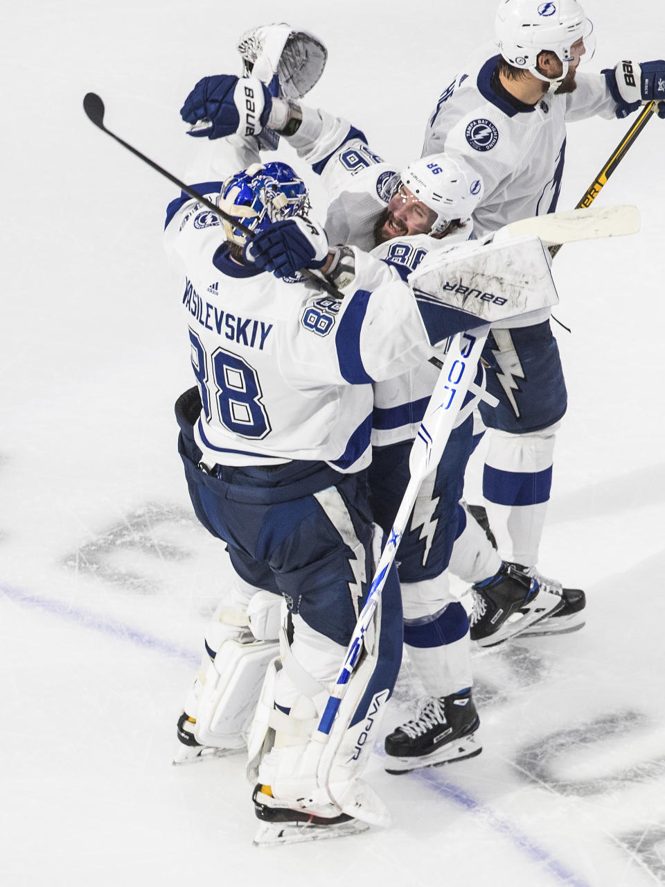 Tampa Bay Lightning goalie Andrei Vasilevskiy (88) and teammate Nikita Kucherov (86) celebrate the team's overtime win against the New York Islanders in Game 6 of the NHL hockey Eastern Conference final, Thursday, Sept. 17, 2020, in Edmonton, Alberta. (Jason Franson/The Canadian Press via AP)