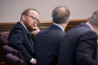 Travis McMichael listens to his attorney Robert Rubin before the start of his trial in the Glynn County Courthouse, Tuesday, Nov. 9, 2021, in Brunswick, Ga. Travis McMichael along with his father Greg and a neighbor, William "Roddie" Bryan are charged with the February 2020 slaying of 25-year-old Ahmaud Arbery. (AP Photo/Stephen B. Morton, Pool)