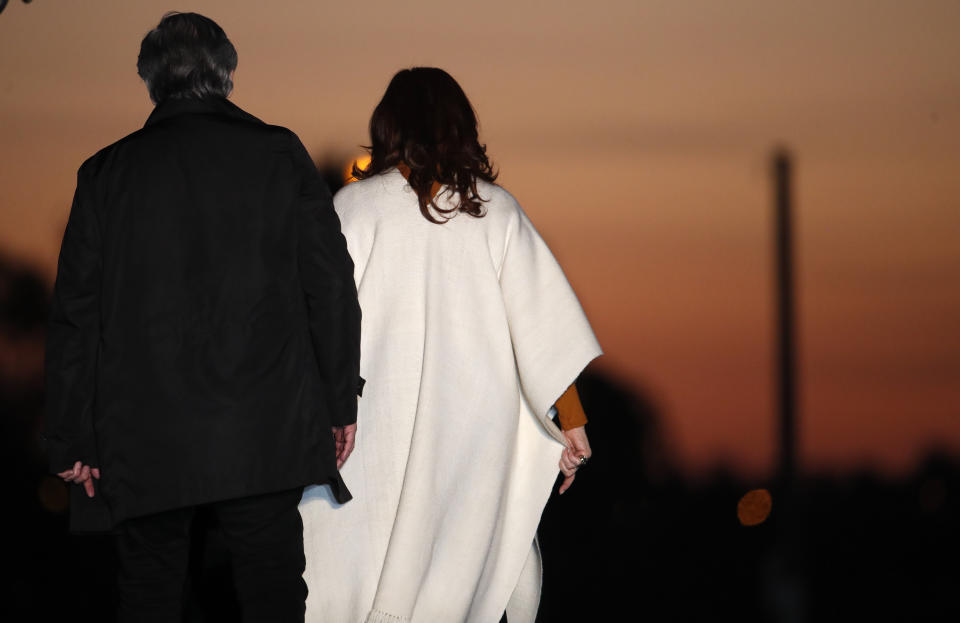 In this Oct. 17, 2019 photo, presidential candidate Alberto Fernandez, left, and running-mate Cristina Fernandez de Kirchner, exit the stage at the end of a campaign rally in Santa Rosa, Argentina. Fernandez de Kirchner faces investigations into alleged fraud, money laundering and other crimes although she enjoys immunity from arrest as a congress member, a status that would also apply as vice president. (AP Photo/Natacha Pisarenko)