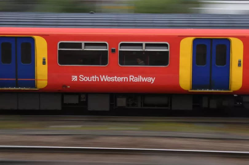 South Western train travels past Clapham Junction station