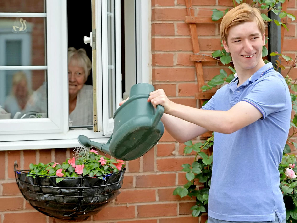 Part of his challenge involved watering neighbours garden plants. (Supplied Ashley Hall/SWNS)