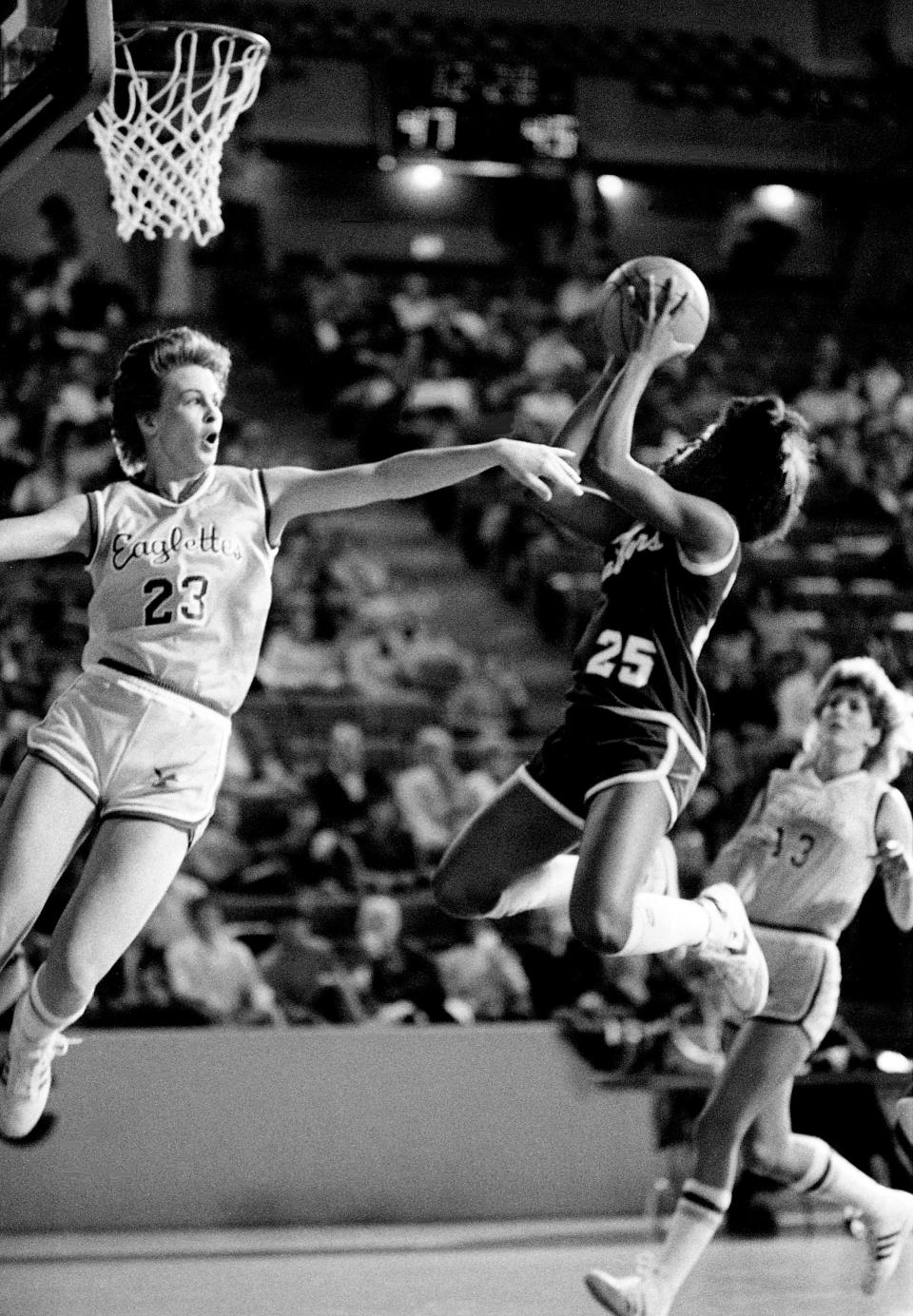 Middle Tennessee State freshman Kim Webb (25) finishes off a drive with a shot at the goal over Tennessee Tech’s Tammy Burton during OVC action on Jan. 7, 1984, at Hooper Eblen Center in Cookeville. MTSU won the game 70-66.