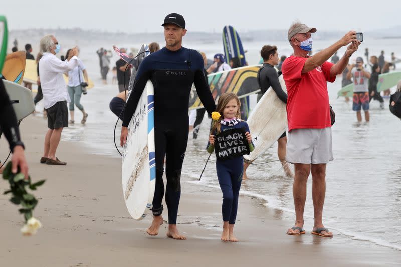 People prepare to surf at The Black Girls Surf paddle-out in memory of George Floyd, who died in Minneapolis police custody, in Santa Monica