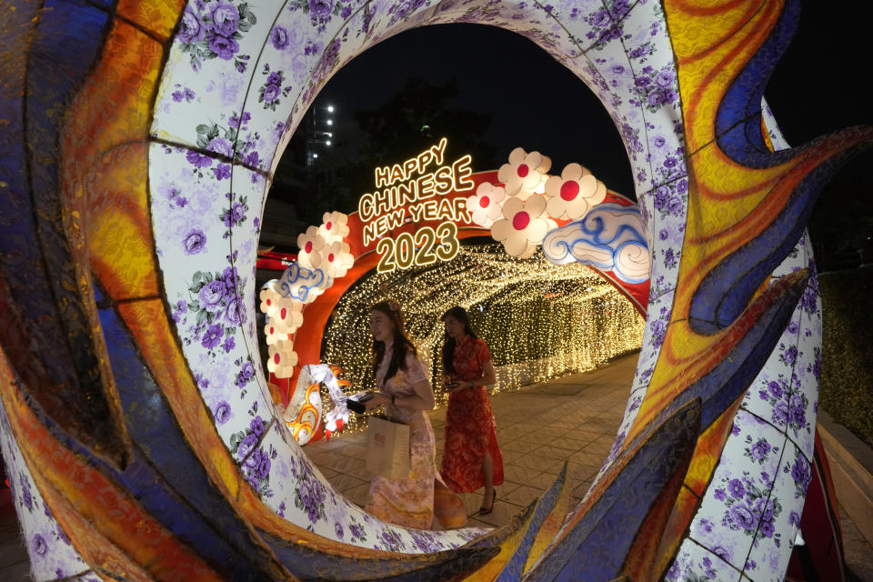 Women walk through decorations for the upcoming Chinese Lunar New Year in Bangkok, Thailand, Thursday, Jan. 19, 2023. Chinese New Year falls on Jan. 22 this year, marking the start of the Year of Rabbit, according to the Chinese lunar calendar. (AP Photo/Sakchai Lalit)