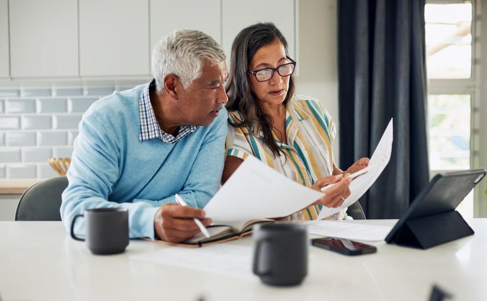 Two people looking at documents together in kitchen.