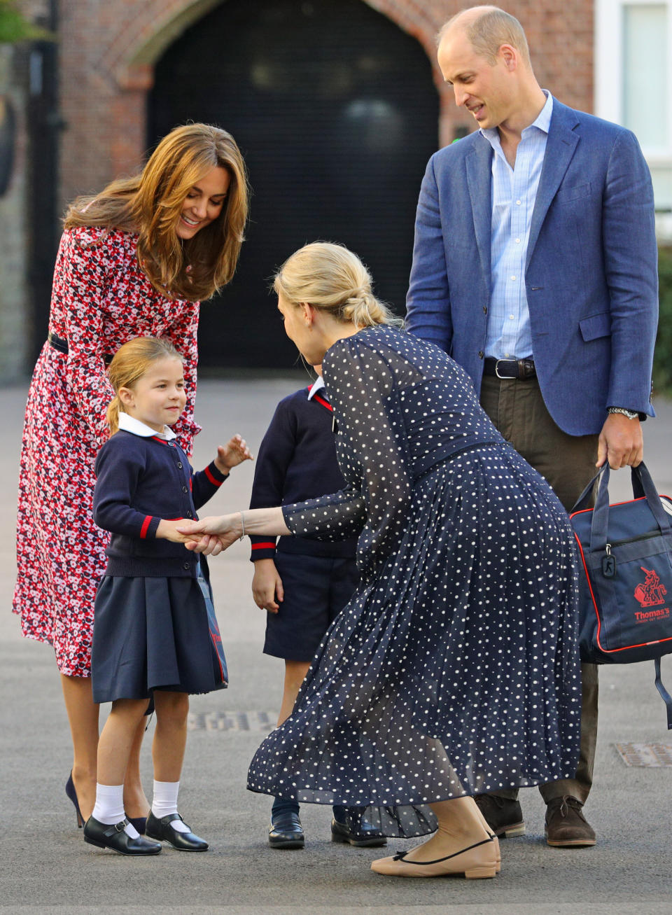 Helen Haslem, head of the lower school, greets Princess Charlotte as she arrives for her first day of school, with her brother Prince George and her parents the Duke and Duchess of Cambridge, at Thomas's Battersea in London on Sept. 5, 2019. (Photo: WPA Pool via Getty Images)