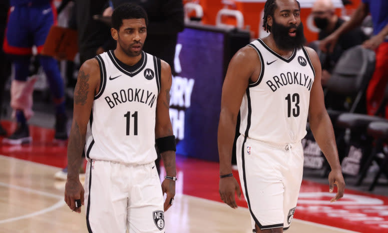 Kyrie Irving #11 and James Harden #13 of the Brooklyn Nets walking down the court