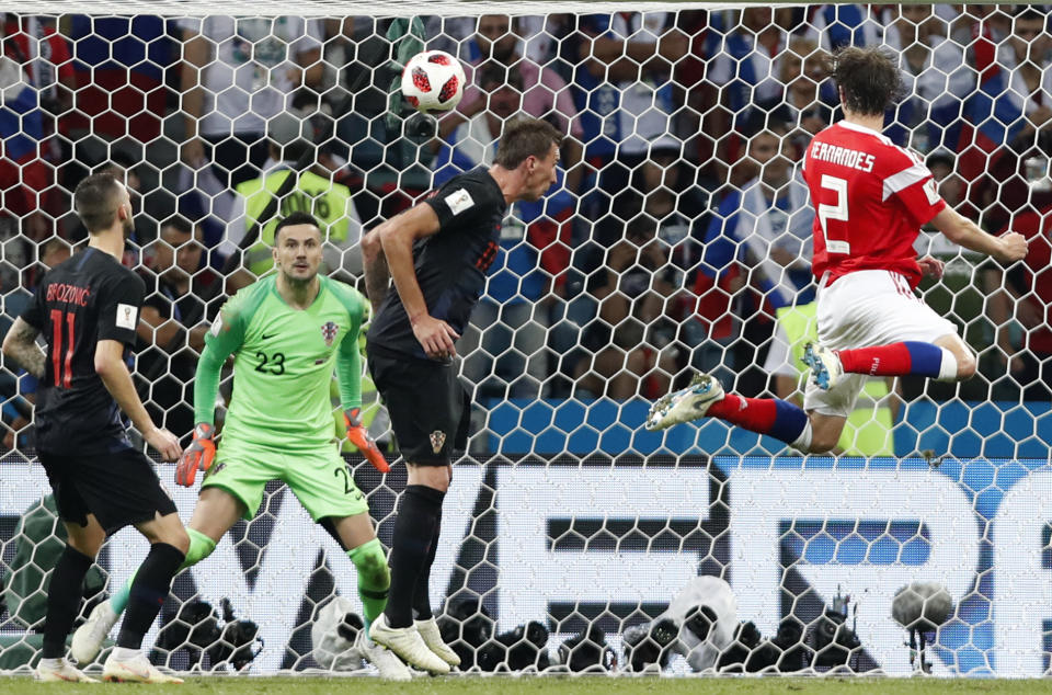 <p>Mario Fernandes leaps highest to send the Russian crowd into raptures </p>