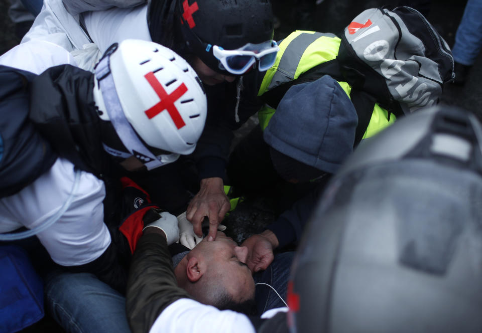 A wounded demonstrator is being taking care by medics during a march Saturday, Jan. 19, 2019 in Paris. Yellow vest protesters are planning rallies in several French cities despite a national debate launched this week by President Emmanuel Macron aimed at assuaging their anger. (AP Photo/Thibault Camus)