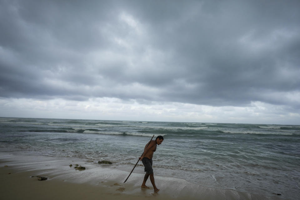 A man practices acrobatics with a pole on the beach in the aftermath by Hurricane Beryl in Tulum, Mexico, Friday, July 5, 2024. (AP Photo/Fernando Llano)