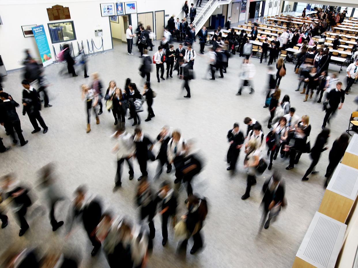 Secondary-aged children walking between classes at their school in Glasgow: Getty