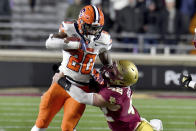 Syracuse's LeQuint Allen is tackled by Boston College's Vinny DePalma during the first half of an NCAA college football game Saturday, Nov. 26, 2022, in Boston. (AP Photo/Mark Stockwell)