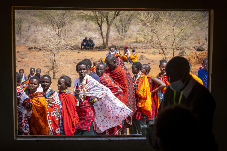 Maasai wait in line to cast their votes look through an open window at electoral officials inside a polling station at Niserian Primary School, in Kajiado County, Kenya Tuesday, Aug. 9, 2022. Elections, coups, disease outbreaks and extreme weather are some of the main events that occurred across Africa in 2022. Experts say the climate crisis is hitting Africa “first and hardest.” Kevin Mugenya, a senior food security advisor for Mercy Corps said the continent of 54 countries and 1.3 billion people is facing “a catastrophic global food crisis” that “will worsen if actors do not act quickly.” (AP Photo/Ben Curtis)