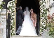 <p>While not officially the matron of honor, Kate acted as any sister would and helped her sister with her train before she walked down the aisle. (Photo: PA) </p>