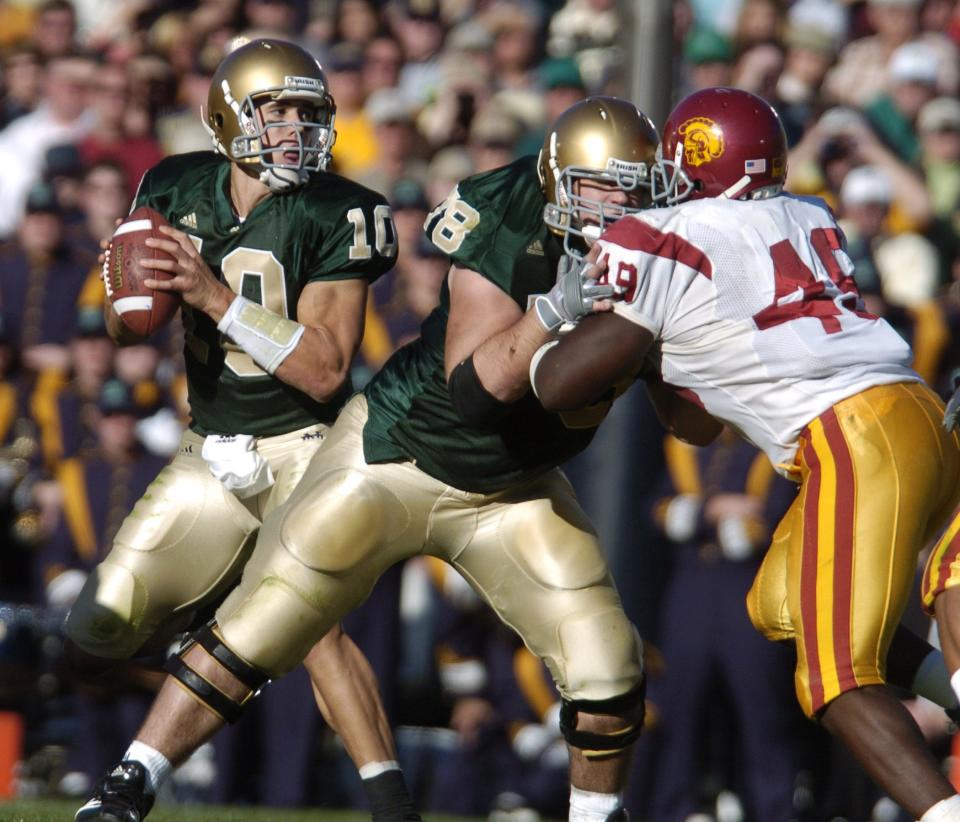 Notre Dame’s Brady Quinn looks for a receiver in the famous USC game in 2005. Quinn, twice a Heisman Trophy finalist at Notre Dame, is excited to see the offense this season under the guidance of new coordinator Tommy Rees and third-year starting quarterback Ian Book.