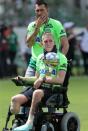 Football Soccer - Chapecoense v Palmeiras - Charity match - Arena Conda, Chapeco, Brazil, 21/1/17. Goalkeeper Jackson Follmann, who survived when the plane carrying Brazilian soccer team Chapecoense crashed, carries the Copa Sudamericana trophy with his teammate Nivaldo before a charity match between Chapecoense and Palmeiras. REUTERS/Paulo Whitaker