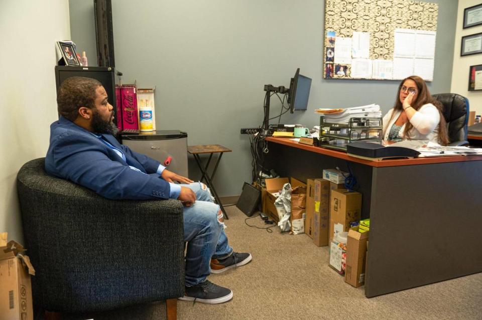 Hoping to find more employers for Dads Against Crime’s job placement services, Andre Harris, left, meets with Lindsey Weidenfeller, human resources manager at Weidenhammer New Packing. Zachary Linhares/The Kansas City Star