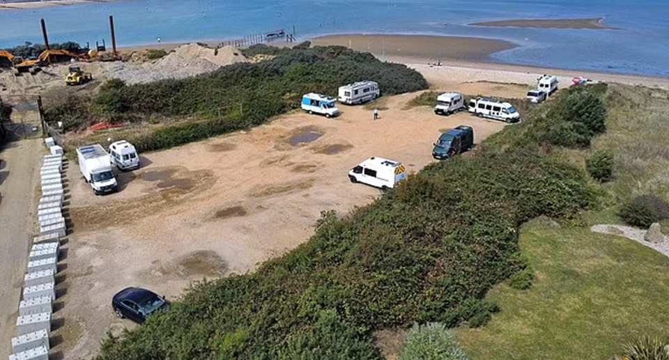 30 large, one meter high concrete bollards in front of the entrance to Bembridge Beach in England. 