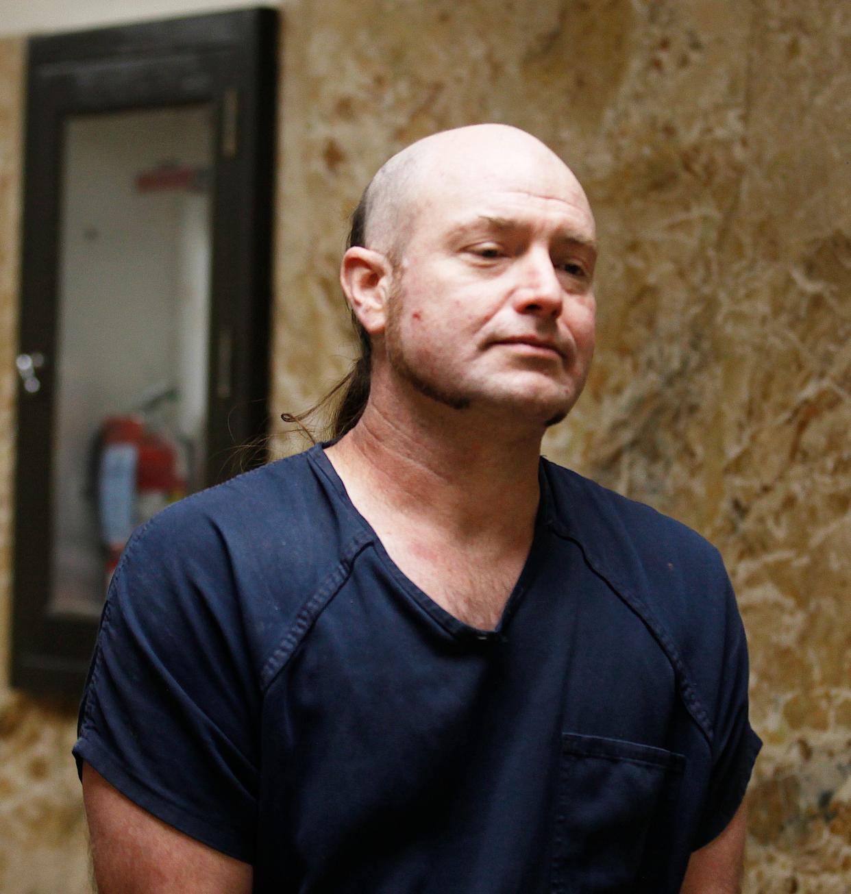 Kethan Anderson, 42, is escorted out of the 364th District Court where he was sentenced to 50 years in prison for strangling to death a homeless man more than three years ago at a condemned home in central Lubbock.