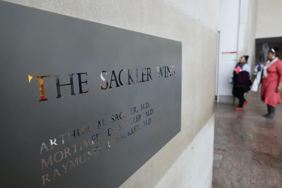 A sign hanging in the Metropolitan Museum of Art's Sackler Wing names all three brothers, Arthur, Mortimer and Raymond.