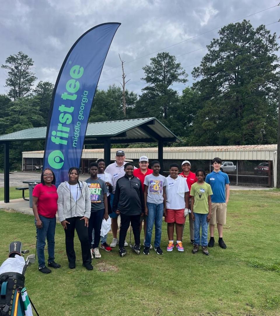 Coaches and participants smile for a photo while attending the First Tee - Middle Georgia May clinic for ages 12 to 18.