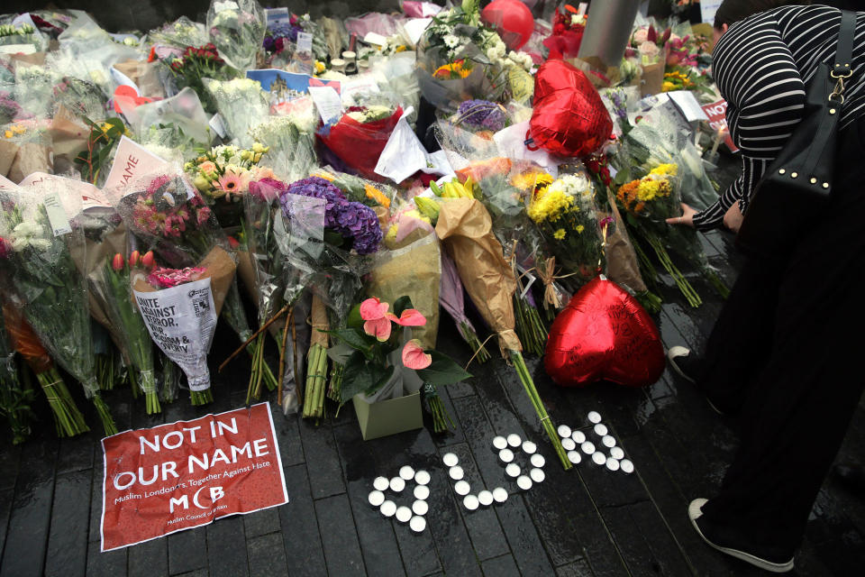 <p>People look at the floral tributes after a vigil for victims of Saturday’s attack in London Bridge, at Potter’s Field Park in London, Monday, June 5, 2017. Police arrested several people and are widening their investigation after a series of attacks described as terrorism killed several people and injured more than 40 others in the heart of London on Saturday. (Photo: Tim Ireland/AP) </p>
