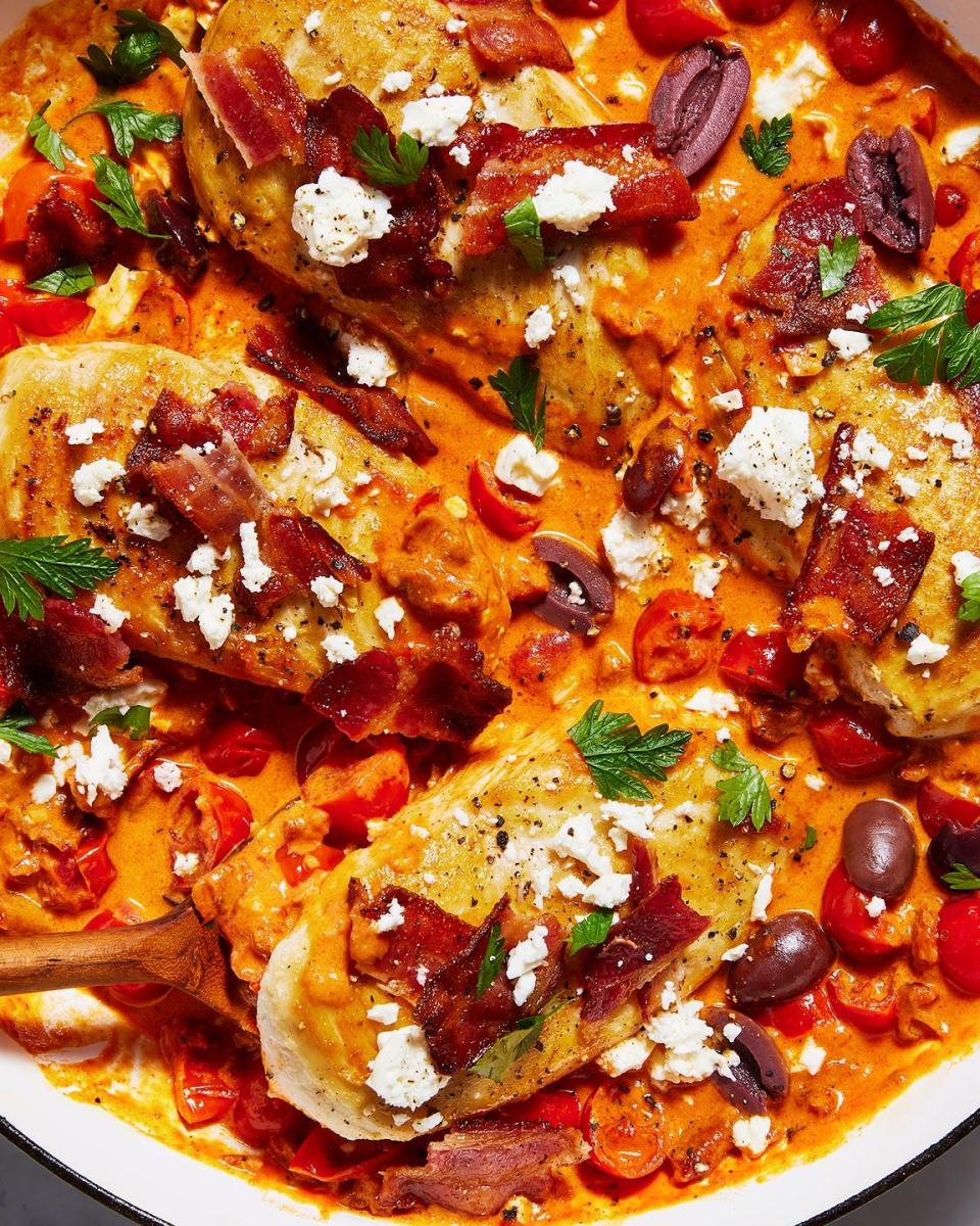 chicken breasts in a creamy sauce with tomatoes, feta, bacon and olives