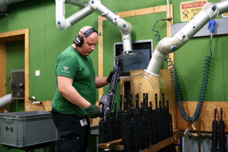 A worker checks the quality of firing of GROT C16 FB-M1, modular assault rifle system at arms factory Fabryka Broni Lucznik in Radom