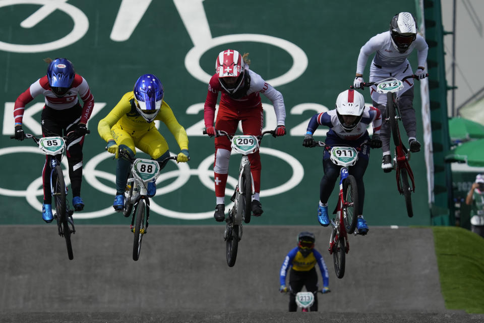 From left to right in foreground, Sae Hatakeyama of Japan, Saya Sakakibara of Australia, Zoe Claessens of Switzerland, Bethany Shriever of Britain, and Vineta Petersone of Latvia, are followed by Chutikan Kitwanitsathian of Thailand during a BMX Racing training session at the 2020 Summer Olympics, Wednesday, July 28, 2021, in Tokyo, Japan. (AP Photo/Ben Curtis)