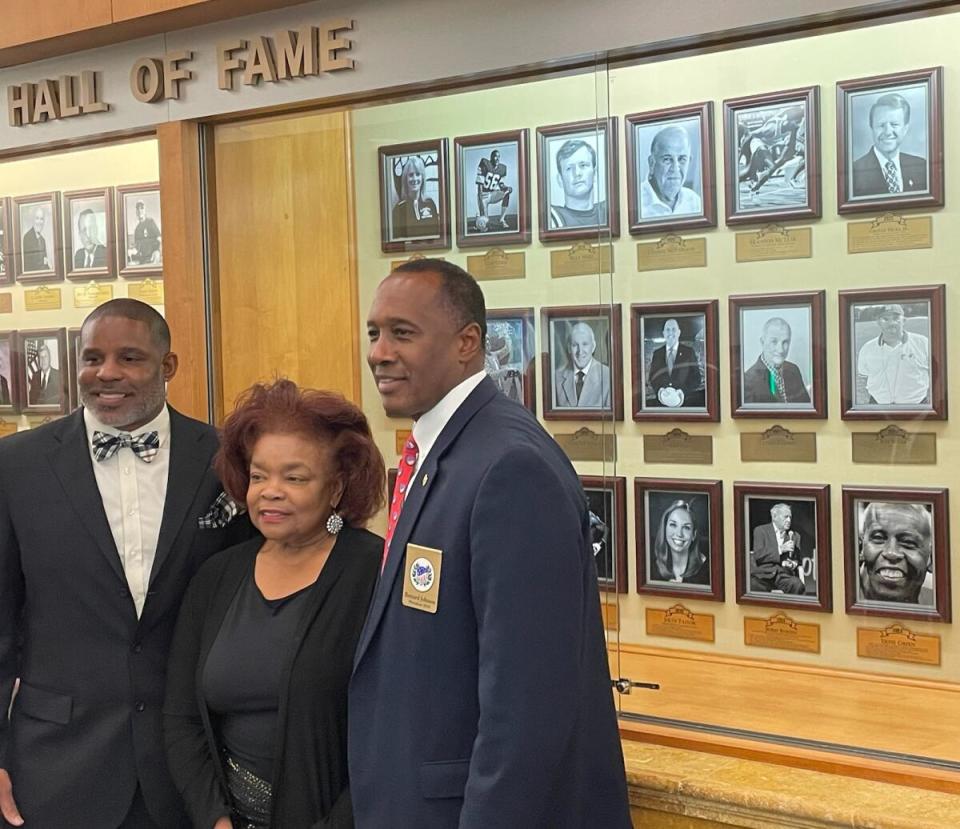 From left, E.G. Green, Vivian Green and former All Sports President Bernard Johnson pose in front of the ASA HOF plaques.