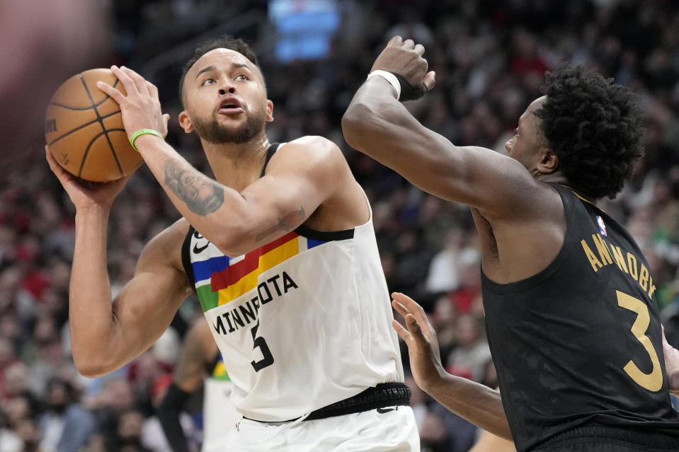 Minnesota Timberwolves forward Kyle Anderson (5) looks for an angle as Toronto Raptors forward O.G. Anunoby (3) defends during the second half of an NBA basketball game, in Toronto, Saturday, March 18, 2023. (Frank Gunn/The Canadian Press via AP)