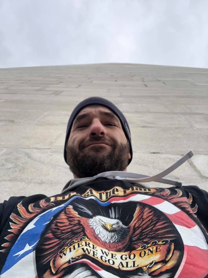 Doug Jensen, an Iowan who was brought into custody for involvement in the storming of the U.S. Capitol Jan. 6, posted photos of himself in Washington D.C. on Facebook wearing a QAnon conspiracy theory shirt.