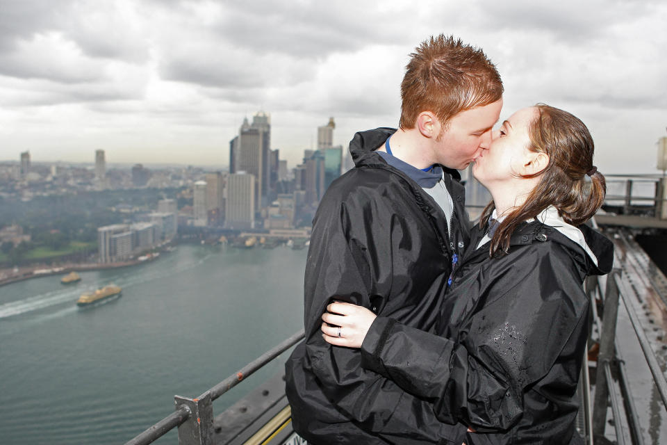 Stephen Tierney and Claire Tullan seal their marriage with a kiss after the first official wedding on the summit of the Sydney Harbour Bridge on June 3, 2008. Source: AFP/Getty Images)