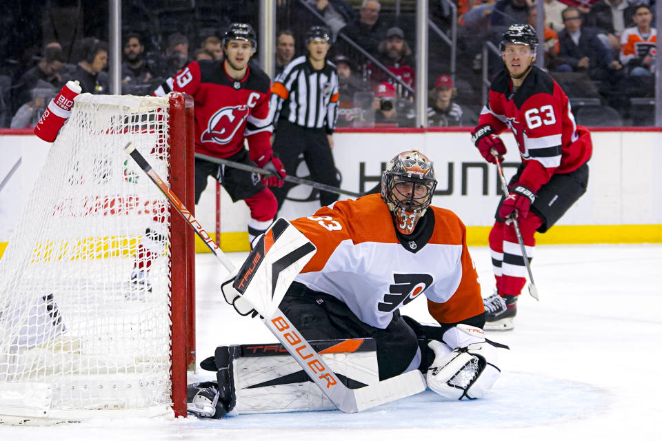 Philadelphia Flyers goaltender Samuel Ersson (33) takes a defensive stance in front of his goal during the second period of an NHL hockey game against the New Jersey Devils in Newark, N.J., Tuesday, Dec. 19, 2023. (AP Photo/Peter K. Afriyie)