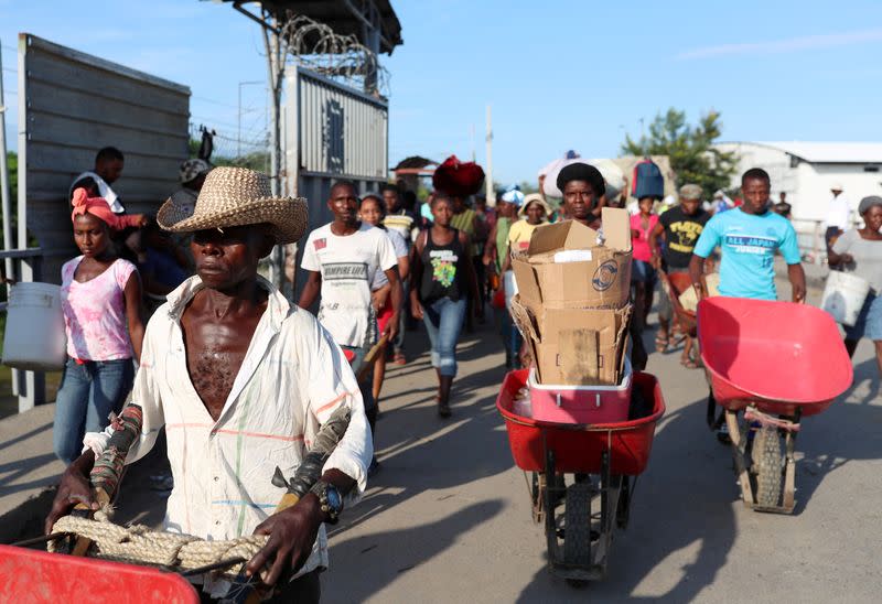 FILE PHOTO: Haitians cross the border between Haiti and the Dominican Republic to sell Haitian products at a market in Dajabon