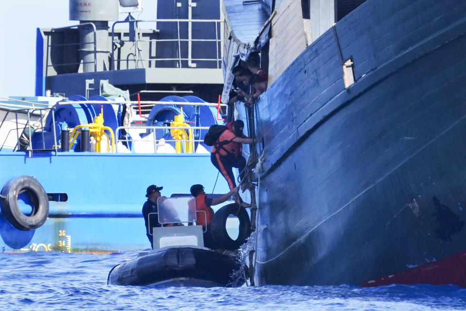 Philippine coast guard personnel alight from resupply vessel Unaizah May 4 after treating injuries on multiple crew members as their ship was hit by Chinese coast guard water cannon blast, while it tries to enter the Second Thomas Shoal, locally known as Ayungin Shoal, in the disputed South China Sea Tuesday, March 5, 2024. Chinese and Philippine coast guard vessels collided in the disputed South China Sea and multiple Filipino crew members were injured in high-seas confrontations Tuesday as Southeast Asian leaders gathered for a summit that was expected to touch on Beijing's aggression at sea. (AP Photo/Aaron Favila)