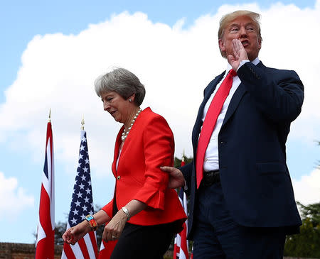 Britain's Prime Minister Theresa May and U.S. President Donald Trump walk away after holding a joint news conference at Chequers, the official country residence of the Prime Minister, near Aylesbury, Britain, July 13, 2018. Reuters photographer Hannah McKay: "This was the third and final time I was photographing Donald Trump during his working visit to the UK. I'd noticed he had a tendency to hold Theresa May by the hand when they used stairs, so I lay on the floor for fifteen minutes waiting for the pair to exit via some steps. As they did, Trump took May by the arm and shouted over his shoulder, "Yes" in response to the question "Mr. President, will you tell Putin to stay out of the U.S elections?" - from a reporter in the press conference." REUTERS/Hannah McKay