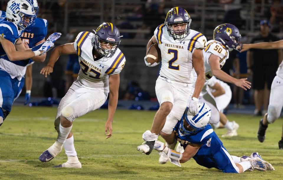 Orestimba’s Juan Esquivez is tackled by Ripon Christian’s Amos Cady on a run during the Southern League game with Ripon Christian in Ripon, Calif., Friday, Sept. 22, 2023.