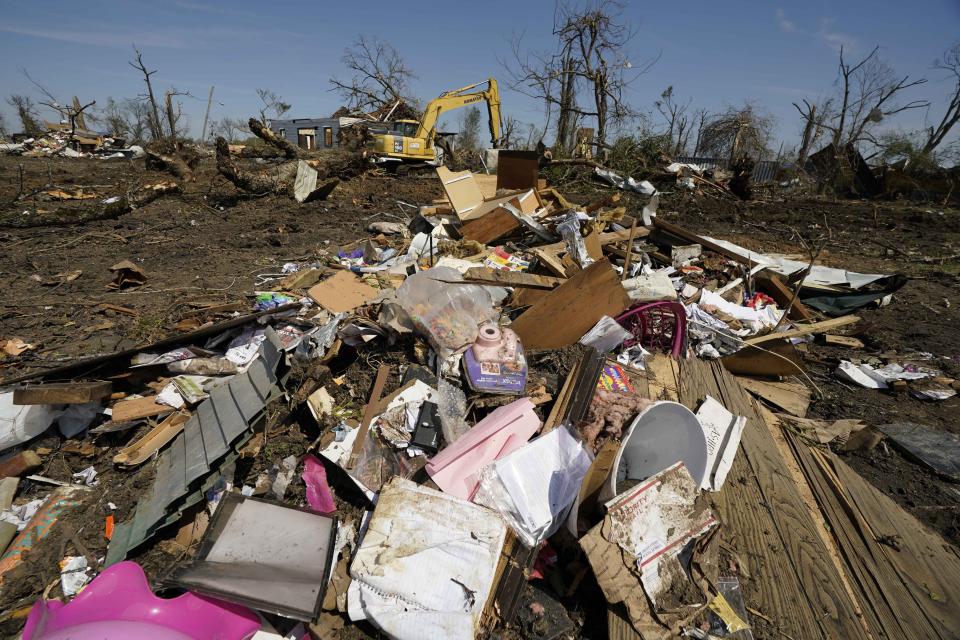 A backhoe works on downed tree removal to facilitate eventual debris removal in Silver City, Miss., which was impacted from Friday's tornado that hit a number of Mississippi communities, Tuesday, March 28, 2023. Many communities are now in the midst of cleanup. (AP Photo/Rogelio V. Solis)