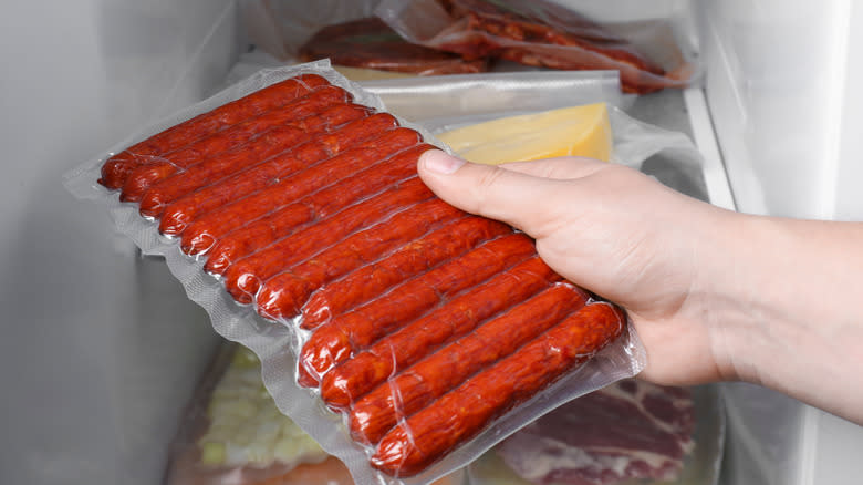 bag of vacuum sealed sausages going into freezer