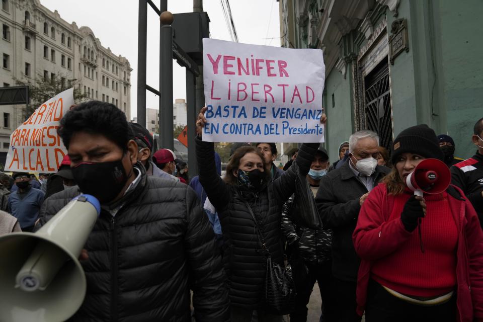 Demonstrators gather outside a court building to show support for Yenifer Paredes, the sister-in-law of Peru´s President Pedro Castillo, in Lima, Peru, Sunday, Aug. 28, 2022. A judge will decide if Paredes should be held in preventive detention for 36 months, as requested by the prosecution for her alleged participation in a corruption network. (AP Photo/Martin Mejia)